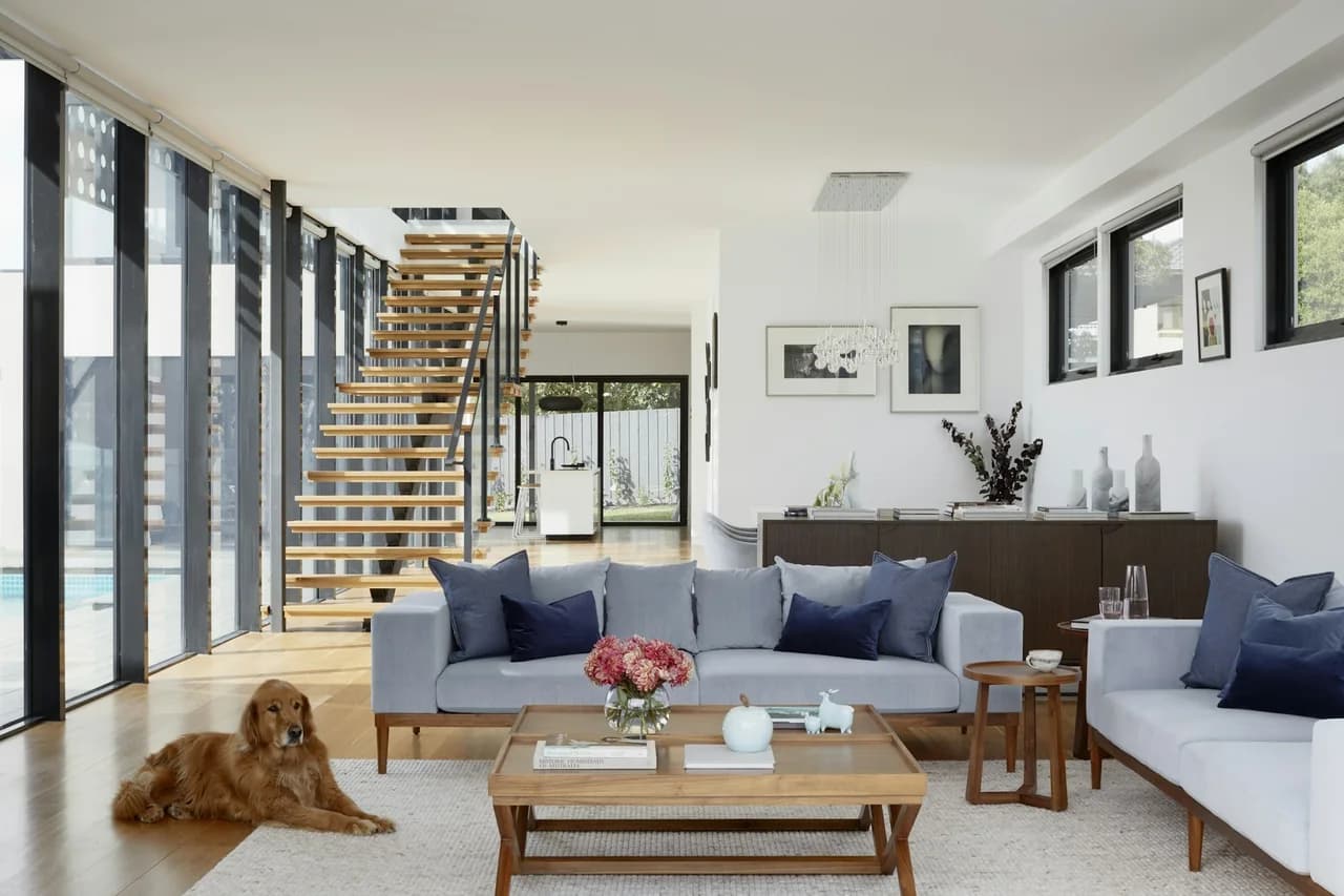Open living room with a dog and warm wood-look flooring